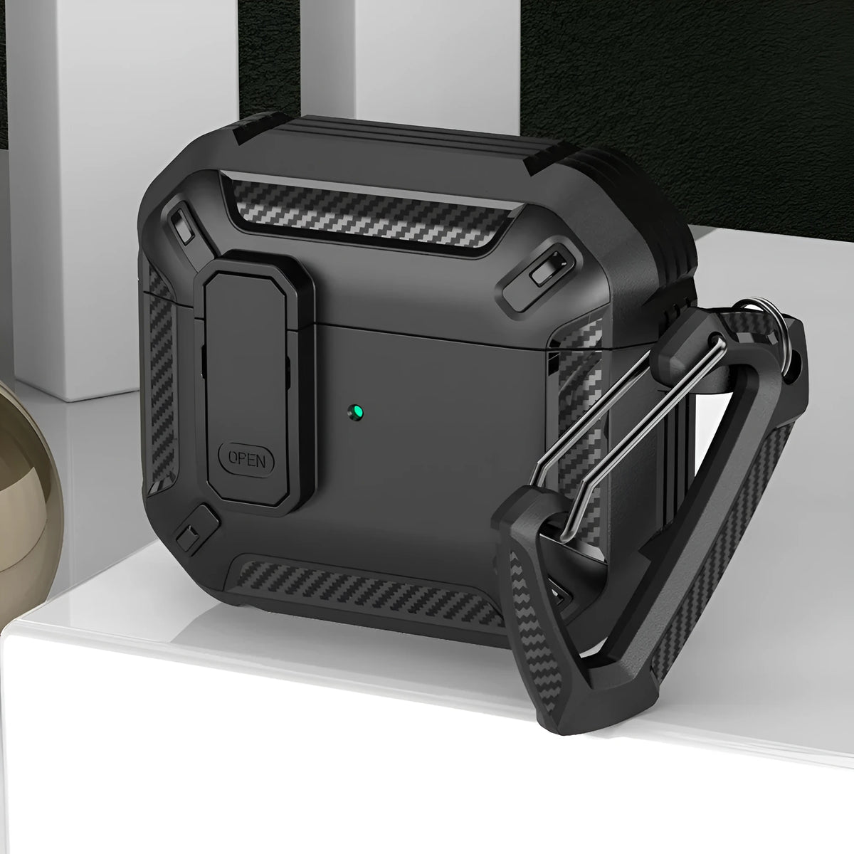 AirPods clamshell protective case in black and yellow, shown with a metal hook accessory.