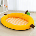Green pet cooling mat with raised fruit backrest for dogs or cats on a wooden floor