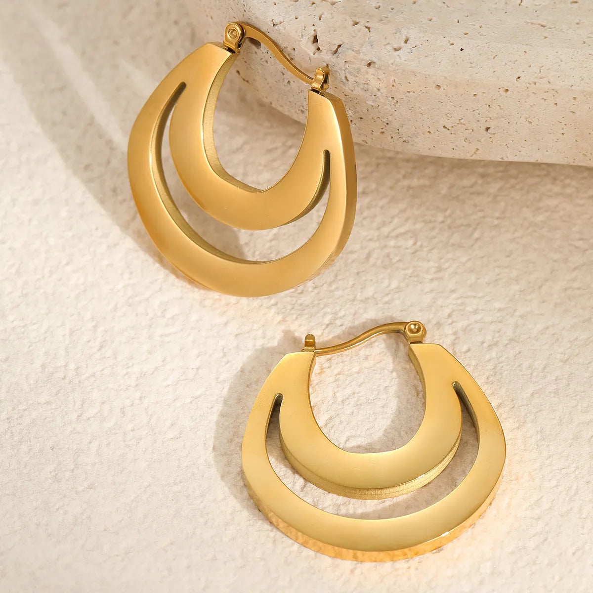 Geometric minimalist French earrings in gold or steel finish with round ring design elements