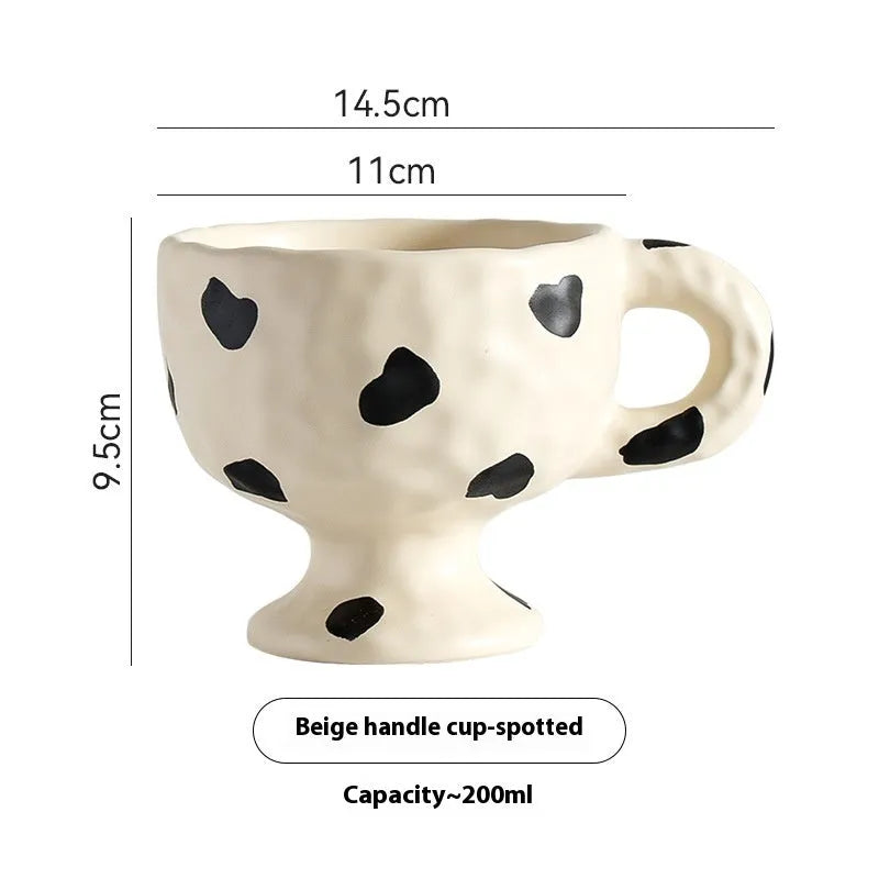 Irregular shaped hand-pinched ceramic mug in solid colour showing unique contours and modern design
