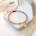 Hand-woven red rope bracelet with strawberry quartz and garnet beads in national tide style
