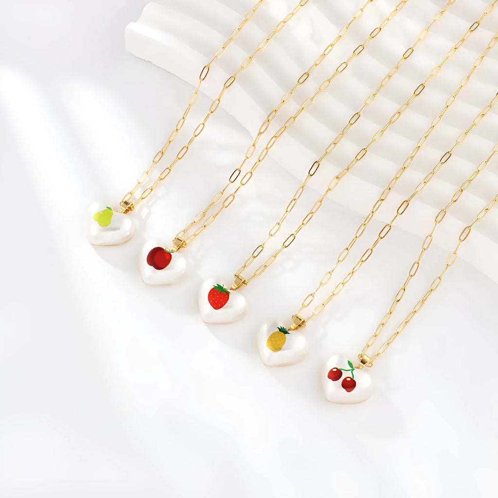 Adjustable heart necklace showing geometric fruit pendants: apple, pineapple, strawberry, cherry, and pear.