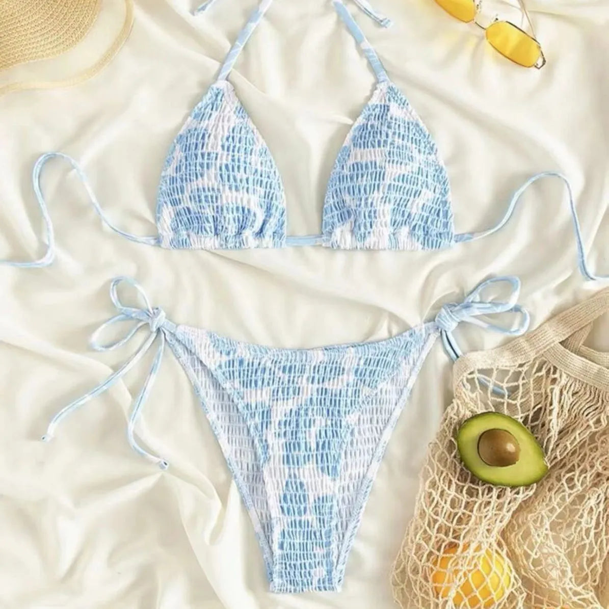 Women's floral print halter bikini swimsuit in light blue colour on a mannequin.