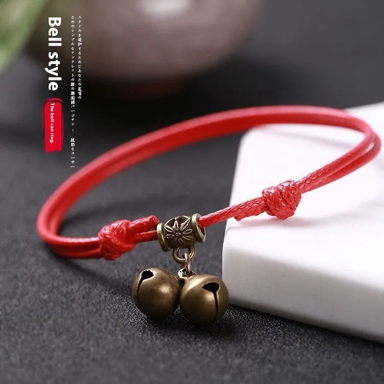 Adjustable nylon dog collar with brass bell on black rope, shown alongside red and coffee colour options.