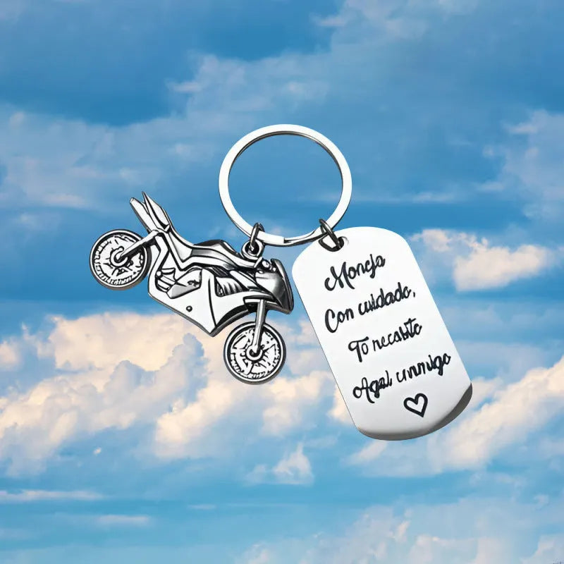 Stainless steel motorcycle keychain with inspirational text and a flannel storage bag.