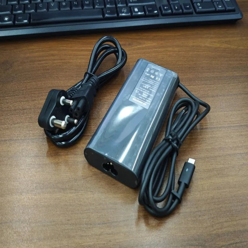 Black oval 65W laptop Type-C charger with six interchangeable international power cords