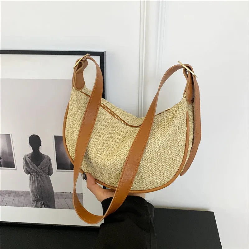 Women's straw woven crossbody bag showing internal mobile phone pocket and file compartment.