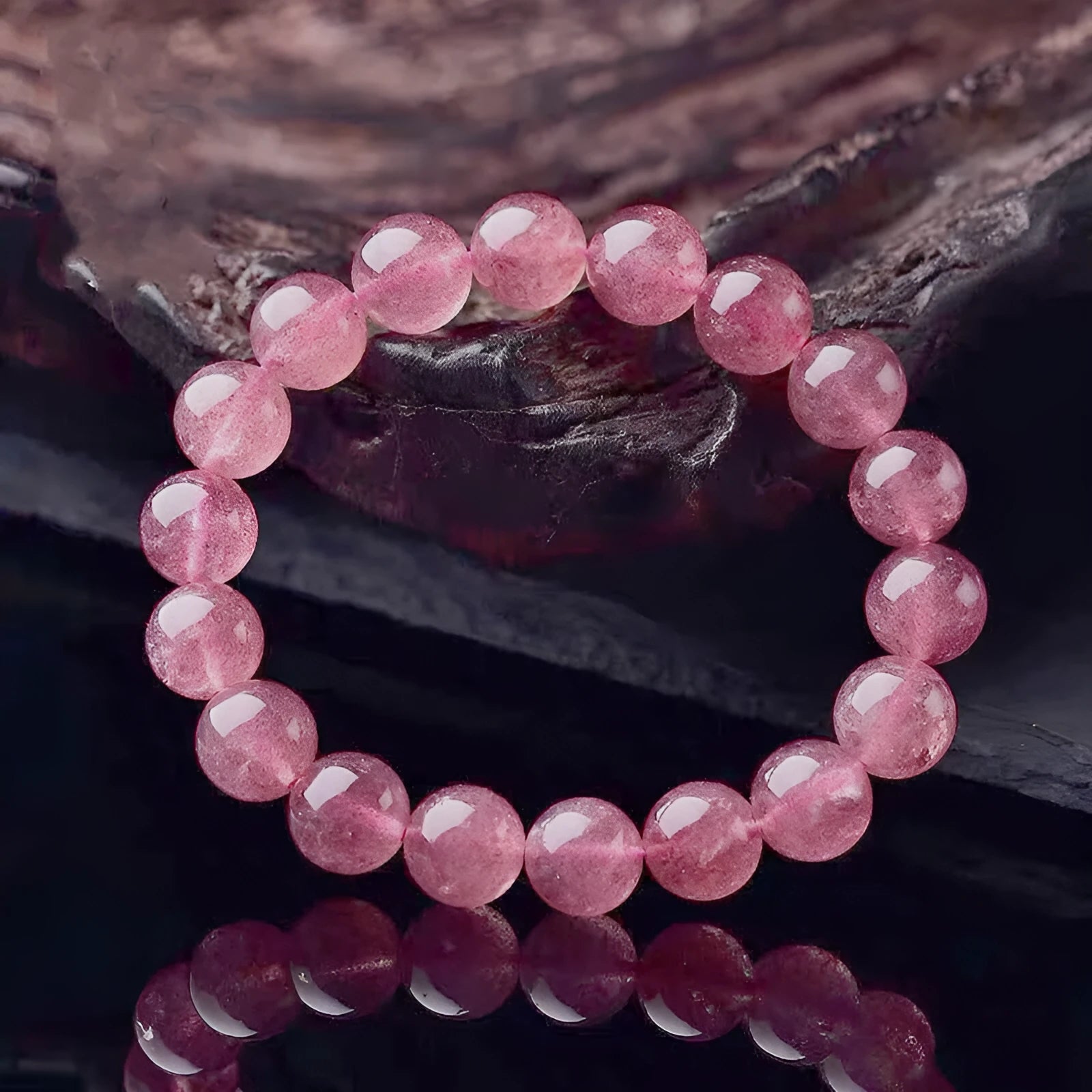 Women's strawberry quartz crystal bracelet with polished beads in 6mm, 8mm, and 10mm sizes