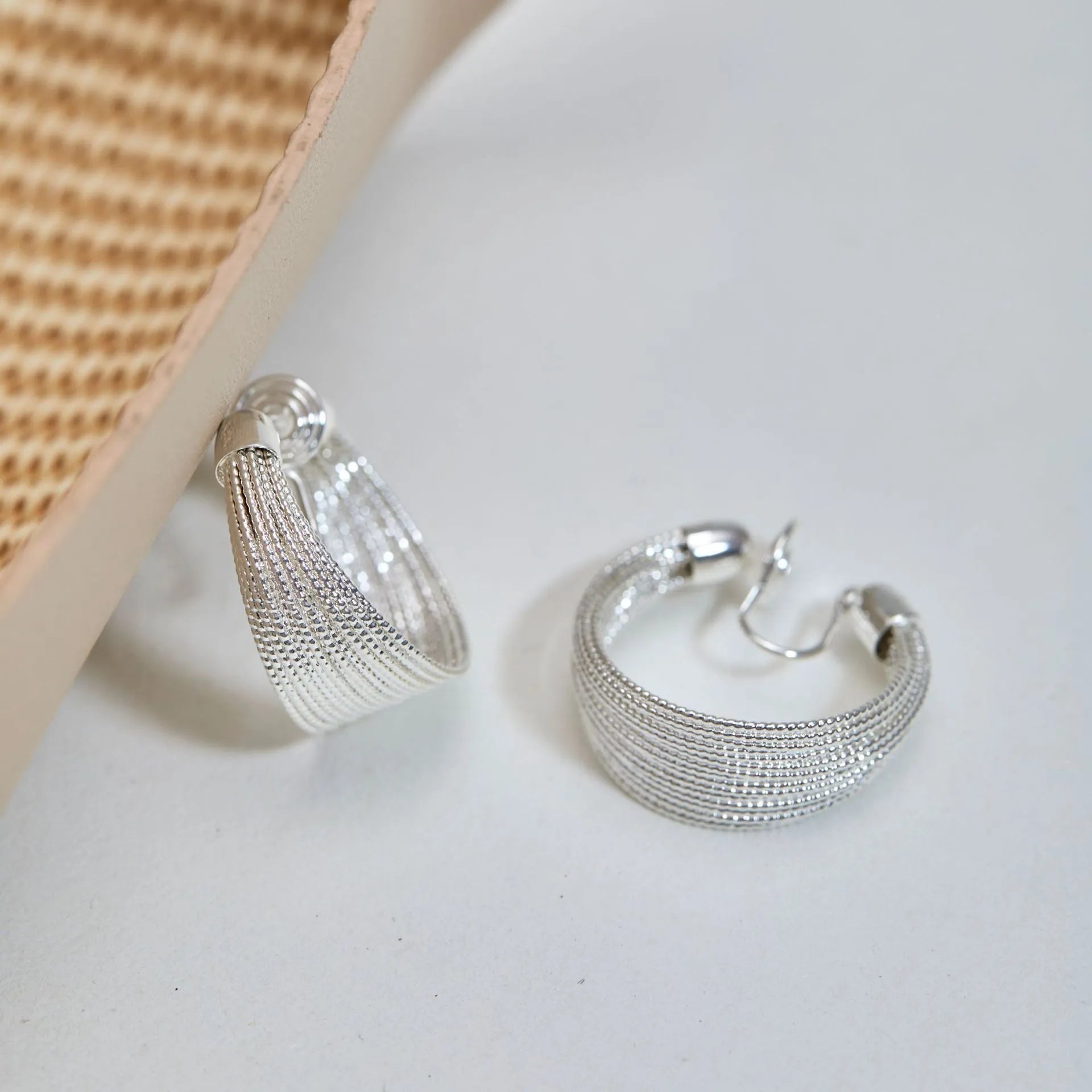 Geometric multi-layer copper earrings with silver or gold electroplated finish, showing stud and clip options