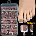 Box of 120 short square false toenails with French white tips, showing nine nude colour options from light to dark.