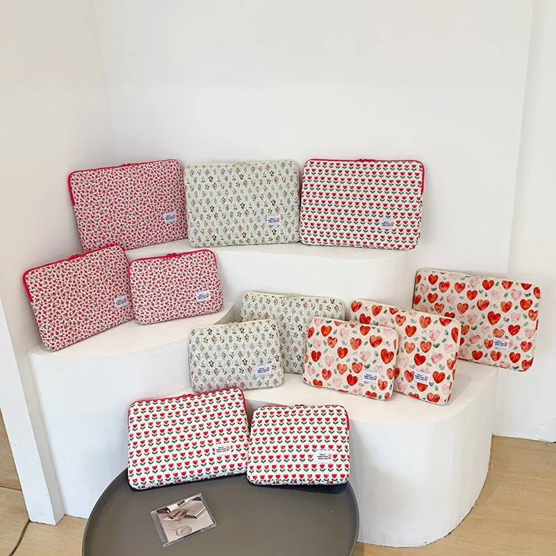 Printed floral design cloth laptop bag for women shown in small, medium, and large sizes.