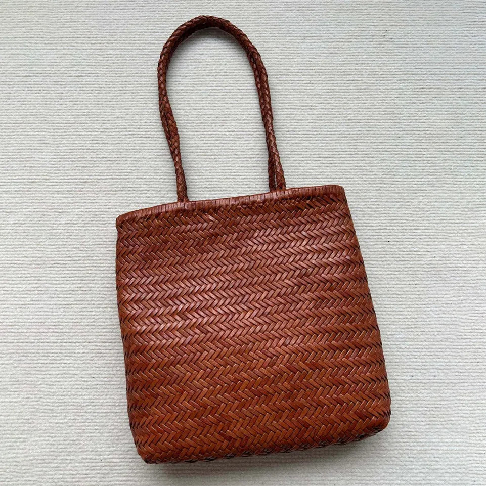Brown woven leather tote bag with three-dimensional outer pocket and genuine cowhide construction