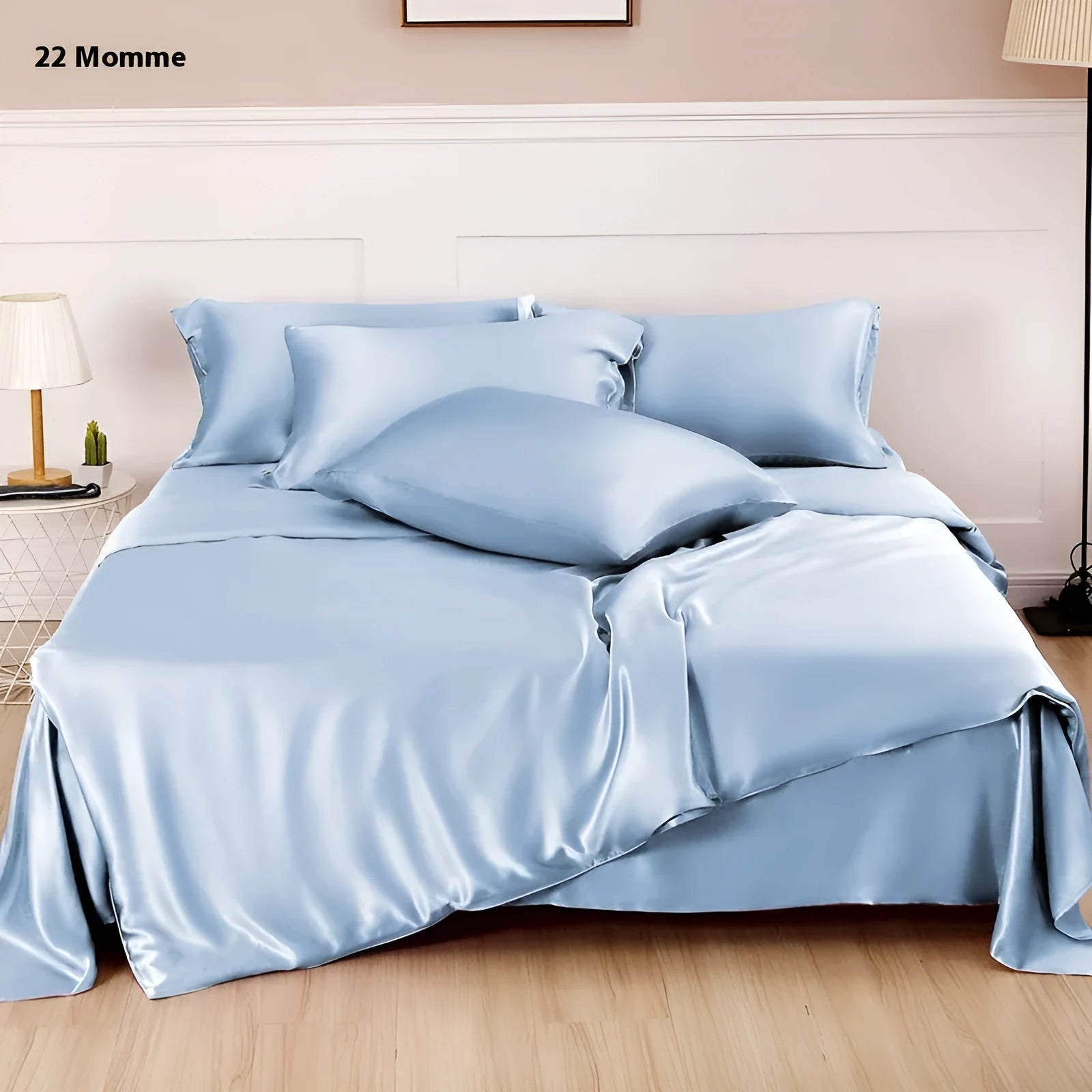 Solid colour silk duvet cover shown in Lotus Pink, laid flat on a bed.