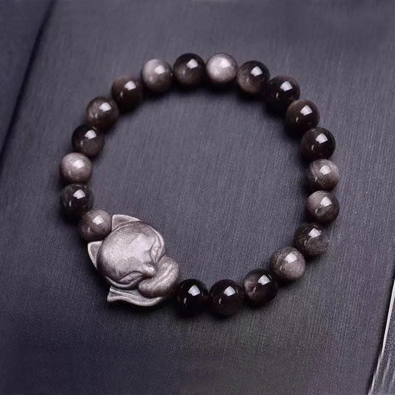 Black obsidian bracelet with fox design featuring 8mm polished stones and adjustable closure