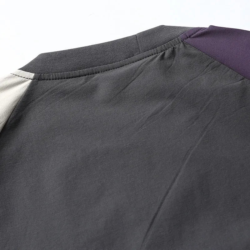 Dark grey loose fit quick-dry t-shirt with contrast raglan sleeves on a hanger.