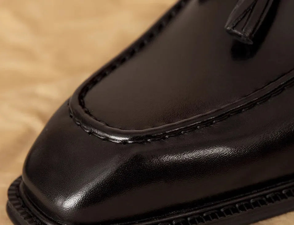 Men's black genuine leather slip-on loafers with fringed detailing and rubber sole