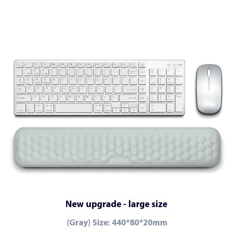 Memory foam mouse wrist pad with silicone bottom in black cloth cover on computer desk