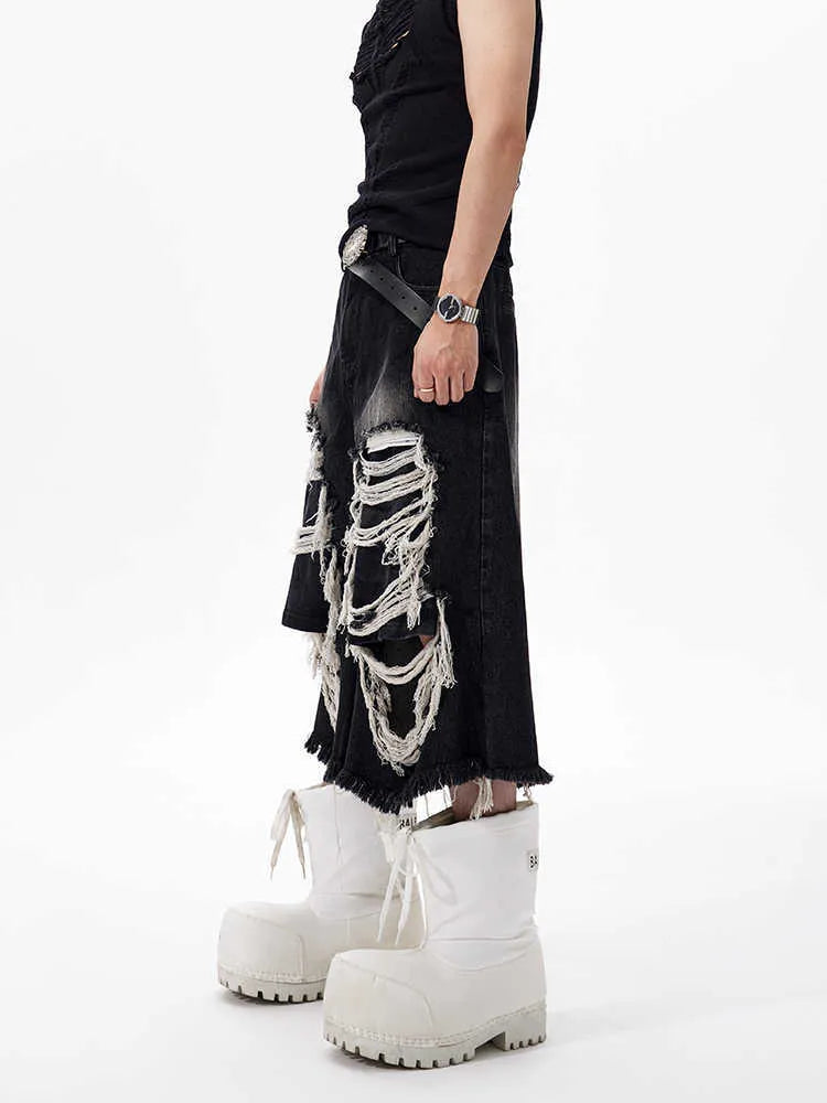 Black women's wide leg cropped jeans with ripped patch detail and a mid-high waist on a hanger.