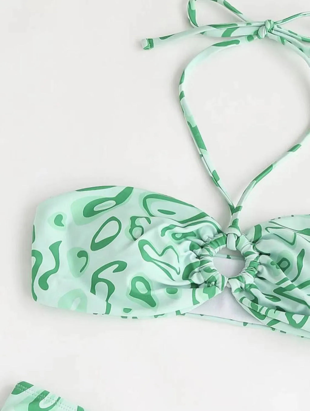 Green floral bandeau bikini with split design and backless styling on swimwear model