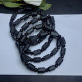 Natural black tourmaline rough stone bracelet showing authentic crystal texture on approximately 9mm beads