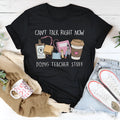 Black straight-cut cotton t-shirt with short sleeves and a round neck on a hanger.