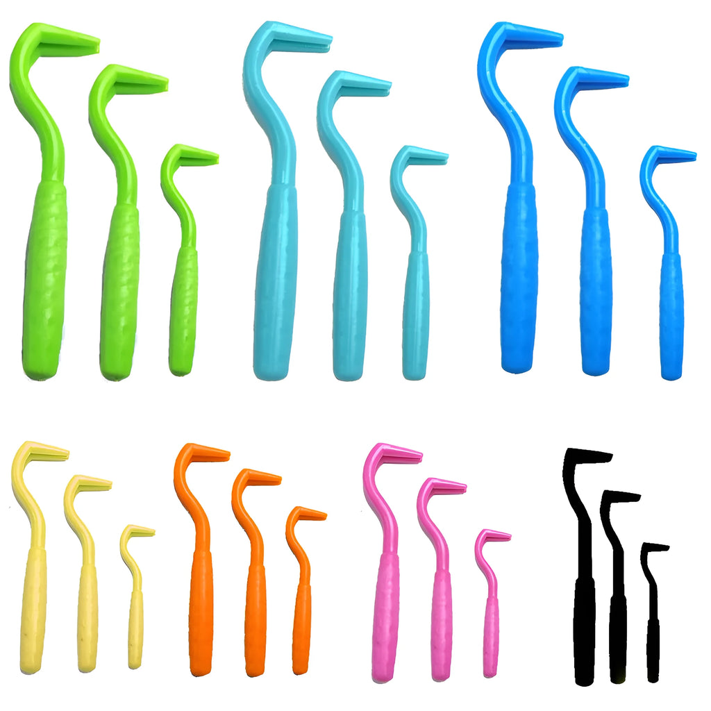 Three plastic tick hooks for dogs in assorted colours on a white background.