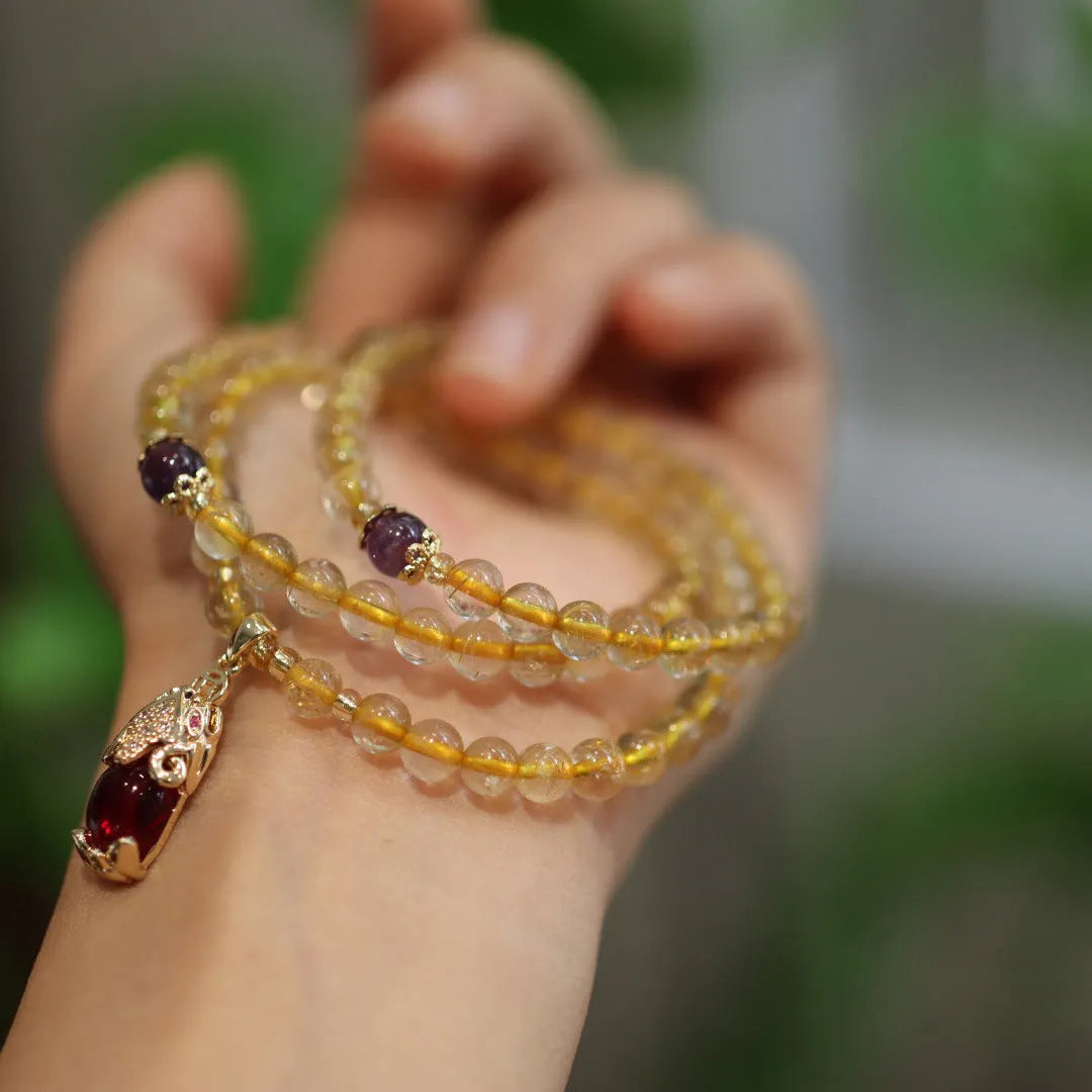 Natural Brazilian gold rutilated quartz bracelet with three-circle gold and ruby quartz design