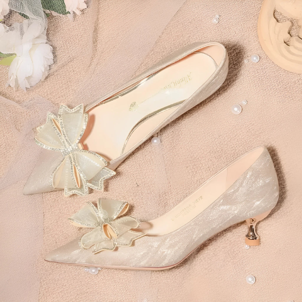 Women's champagne gold sequinned stiletto heel pumps on a white background.