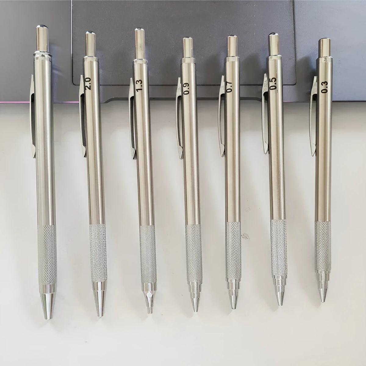 Metal automatic mechanical pencil with five lead size options displayed with 2B refills
