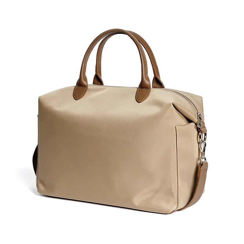 Black large capacity nylon waterproof shoulder bag with leather accents on a plain background.