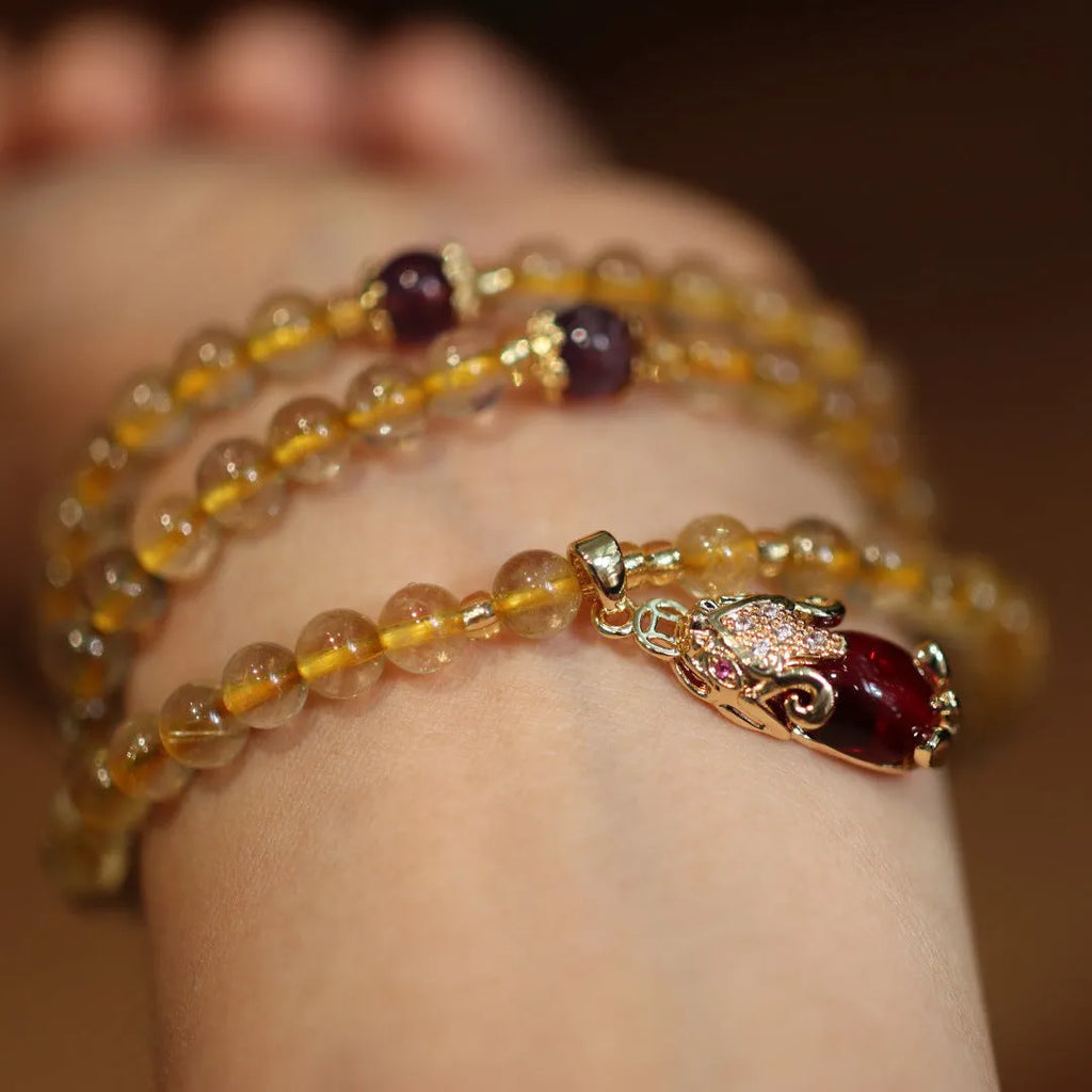 Natural Brazilian gold rutilated quartz bracelet with three-circle gold and ruby quartz design