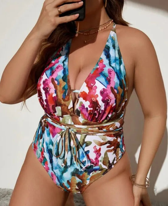 Women's solid colour halter neck one-piece swimsuit on a hanger, available in purple or blue.