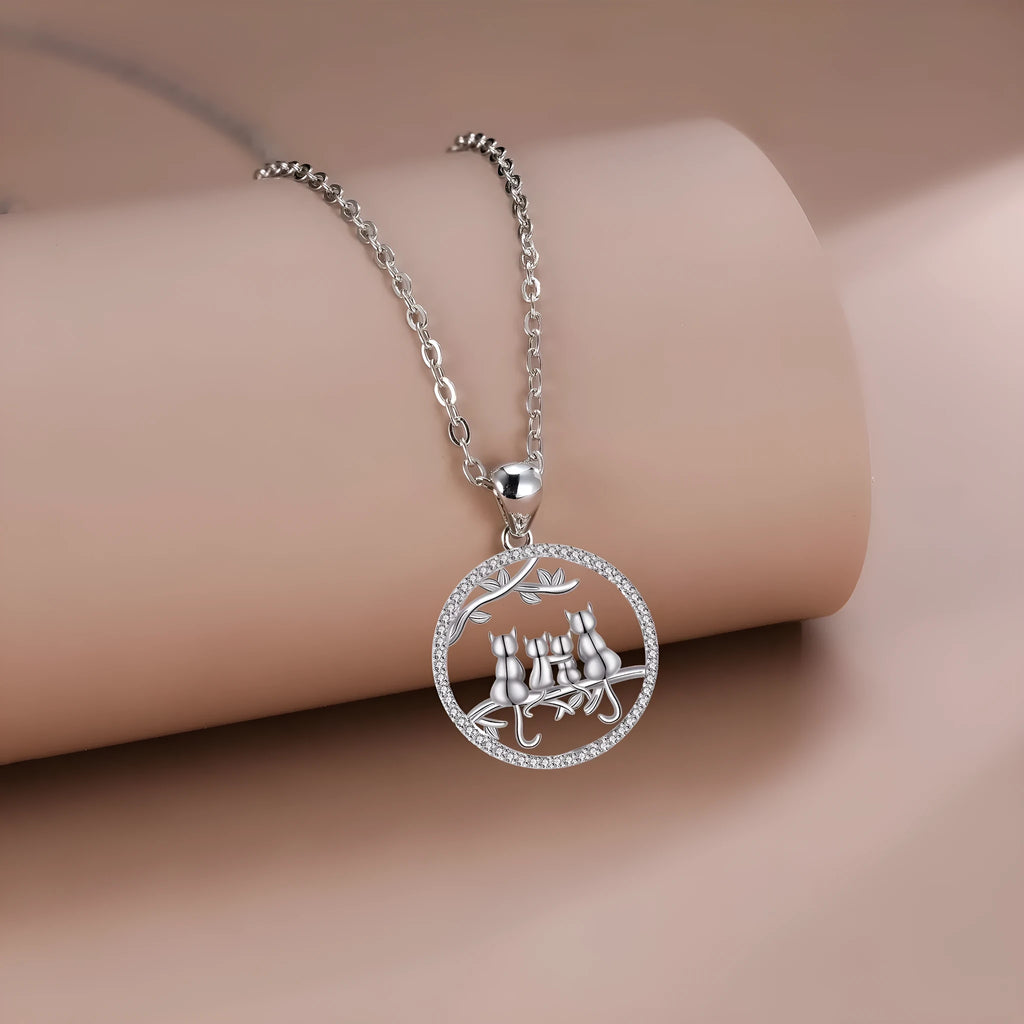 Copper necklace with electroplated four kitten pendant and cross chain.
