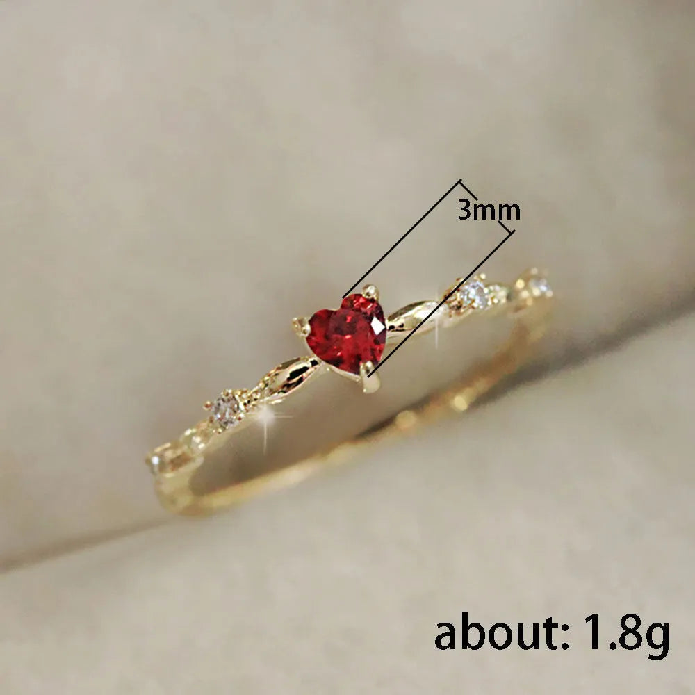 Gold or silver electroplated peach heart fashion ring with zircon stone accents on a copper band.