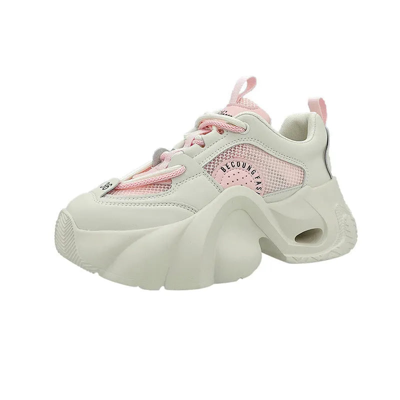 Women's pink casual sneakers with cross shoulder straps and a thick sole.