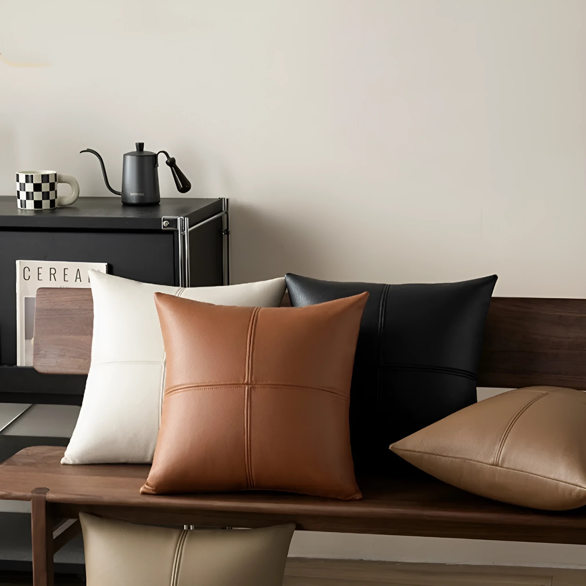 Solid-colour soft cowhide leather pillow cover on a sofa in a Nordic-style living room.