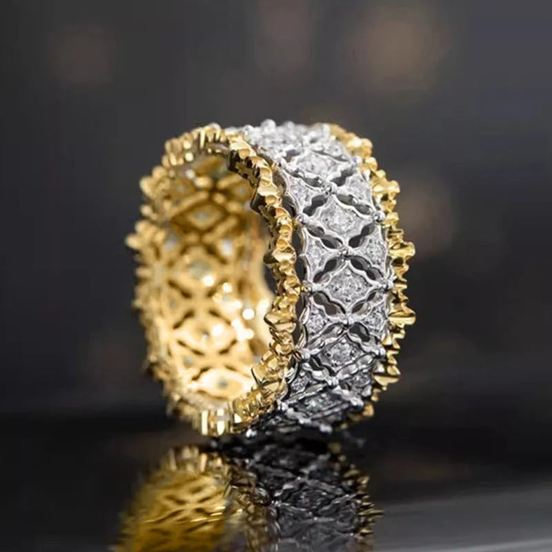 Geometric gold two-tone women's ring with round cubic zirconia stone on copper base.
