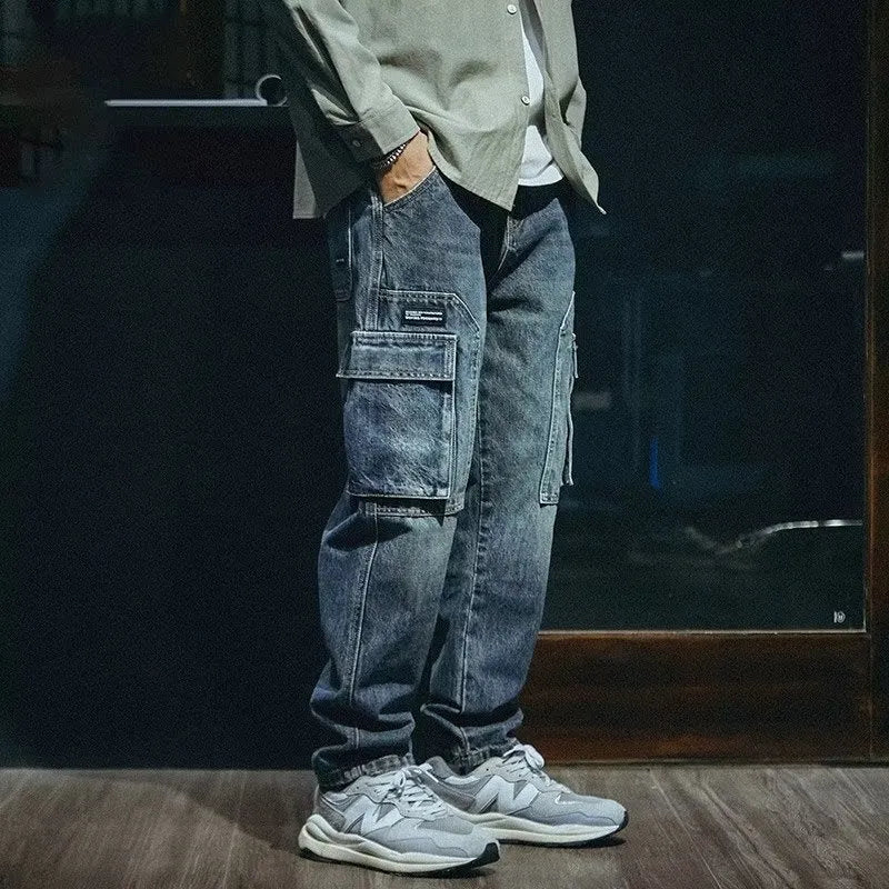 Blue loose straight-leg men's retro jeans with a zip fly on a plain background.
