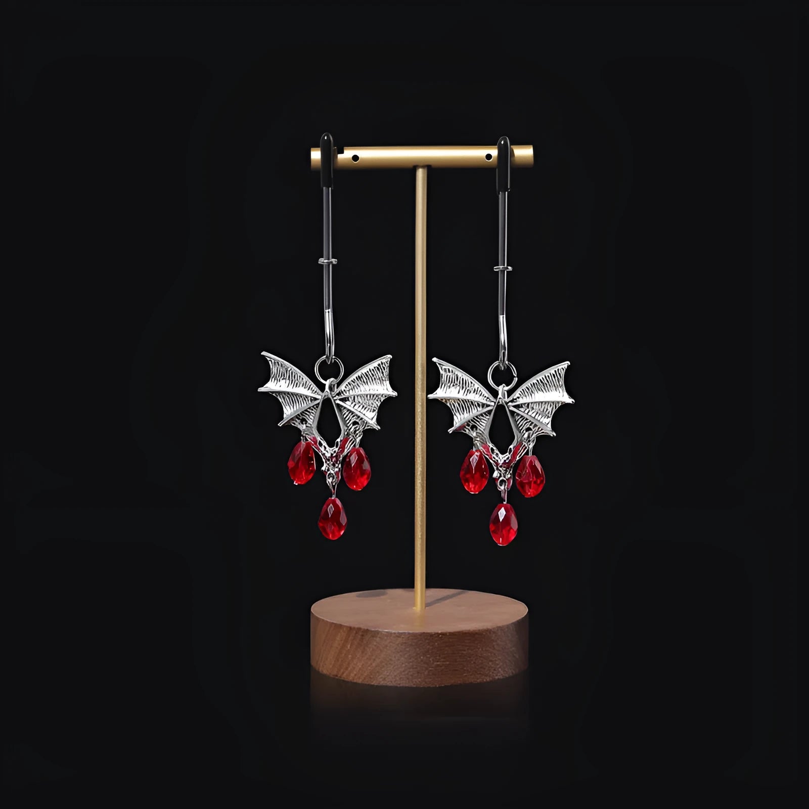 Silver bat-shaped nipple clamps with ruby accents and adjustable pressure mechanism