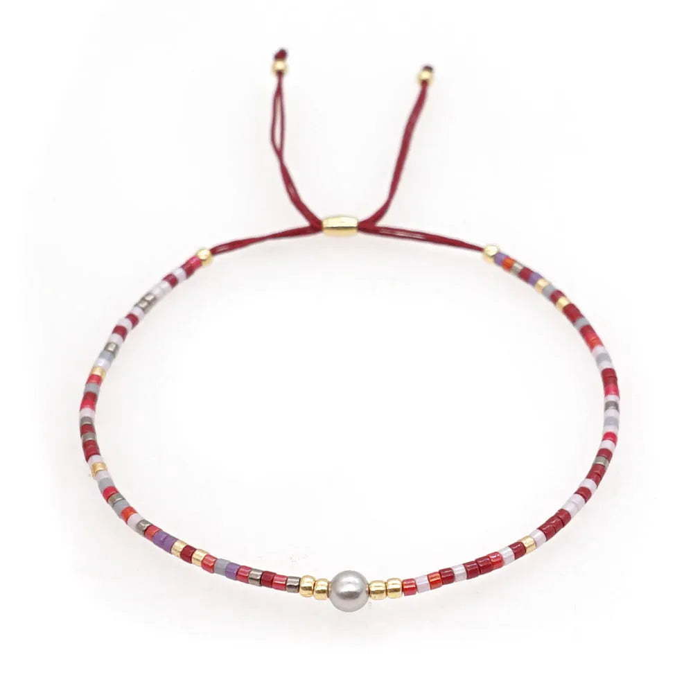 Handmade women's Bohemian bracelet with colourful glass beads and a central lucky stone bead.