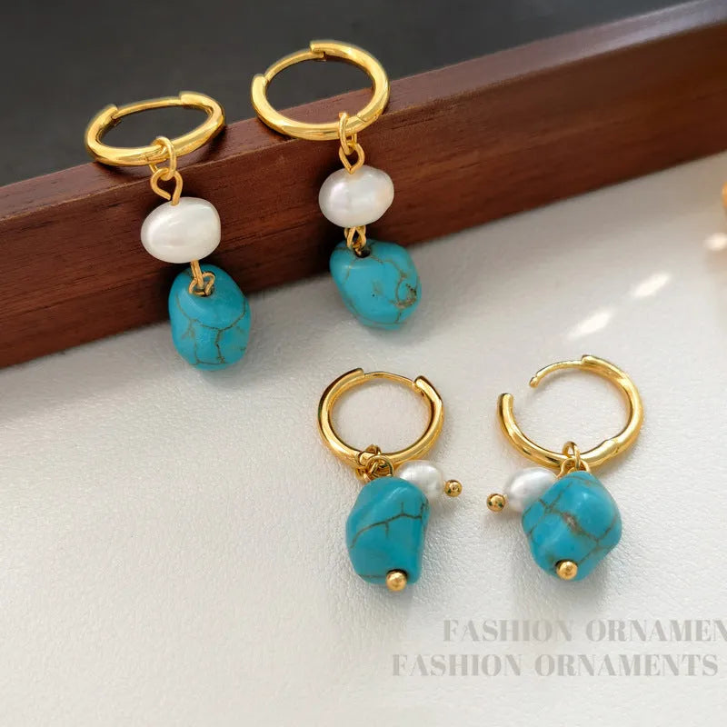 A pair of geometric copper earrings with irregular turquoise stones and cultured pearls