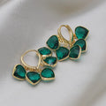 Pair of green heart-shaped glass pendant ear clip earrings with alloy inlay detail.