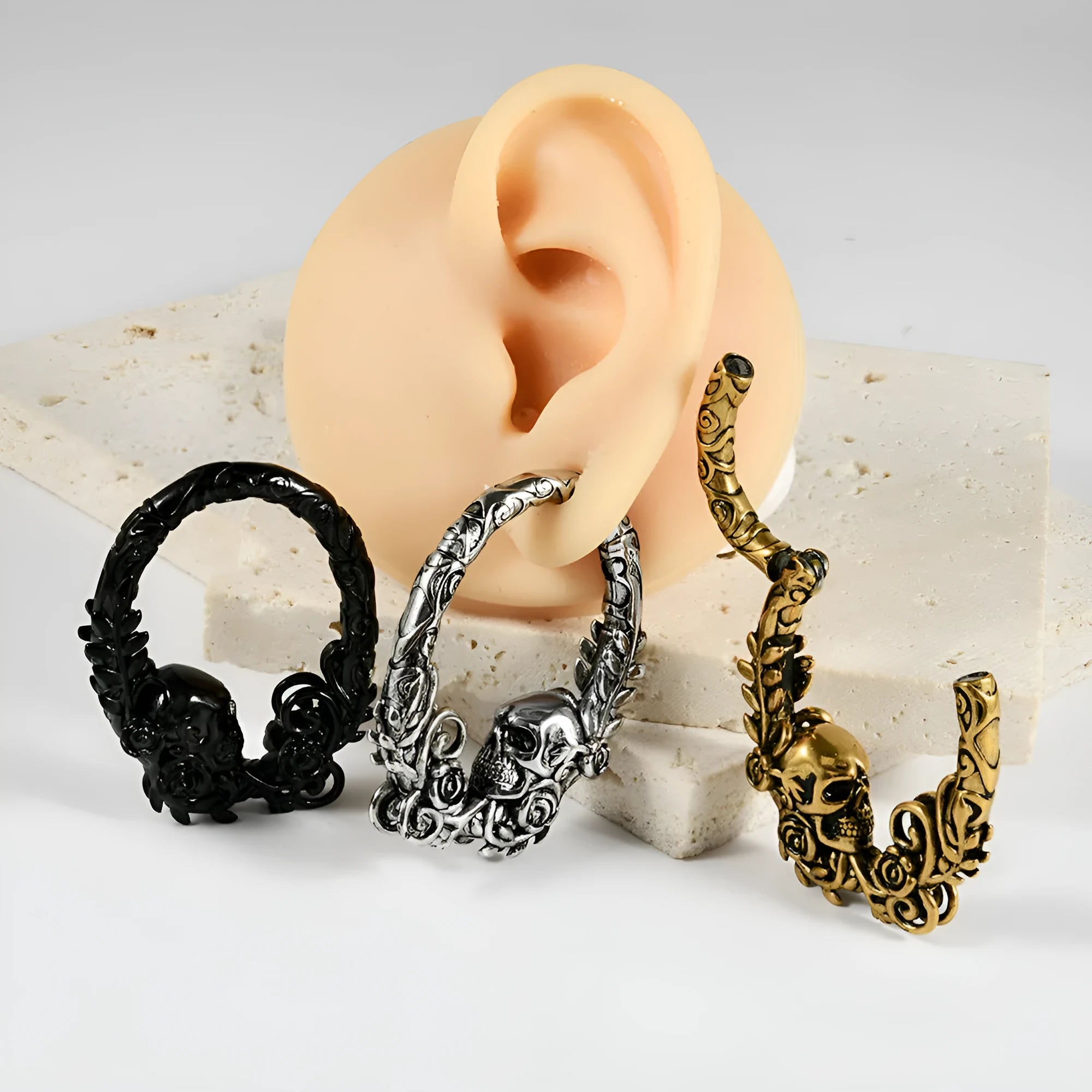 A pair of silver fashion earrings with a raised totem pattern, shown in one of 15 available electroplated colour finishes.