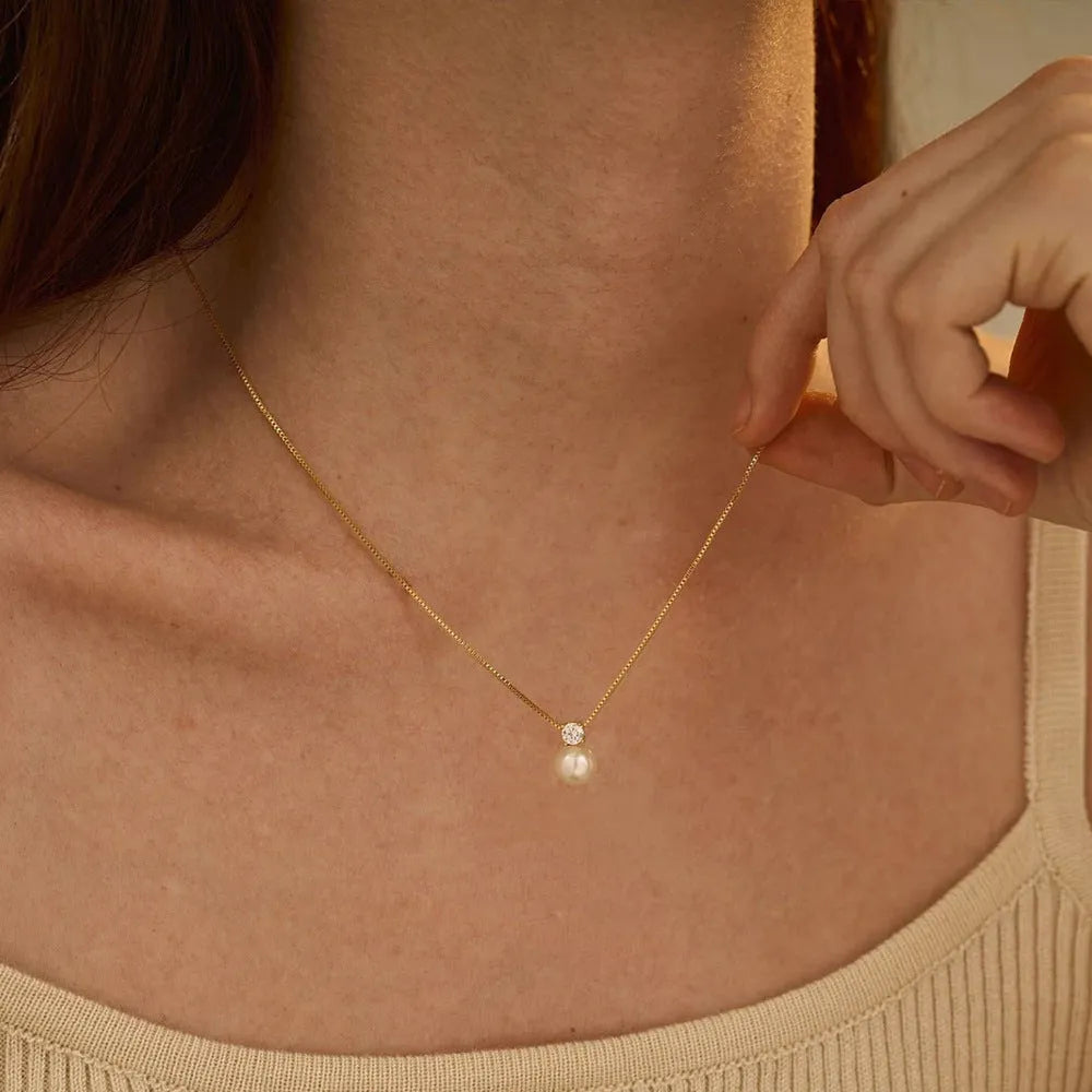 Women's stainless steel necklace with imitation pearl pendant and zircon accents