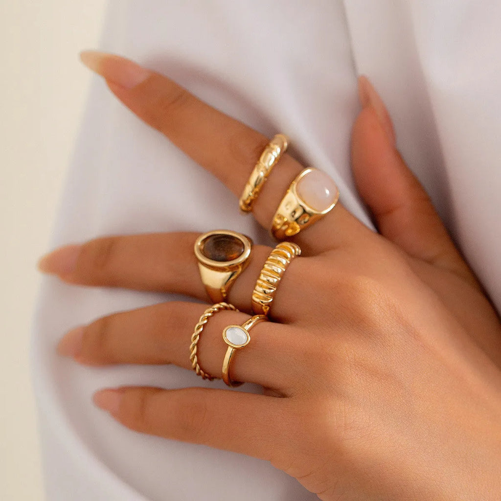 Six geometric alloy rings with light gold electroplated finish arranged in set