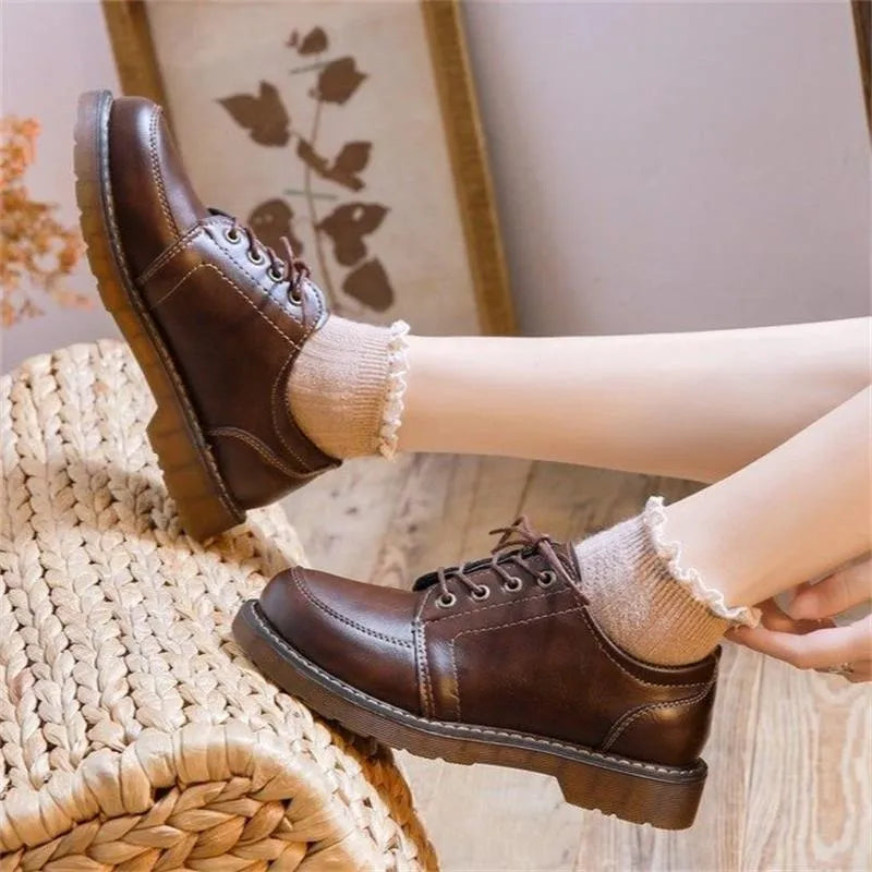 Women's black retro preppy Mary Jane shoes with front lace-up and low square heel on a white background