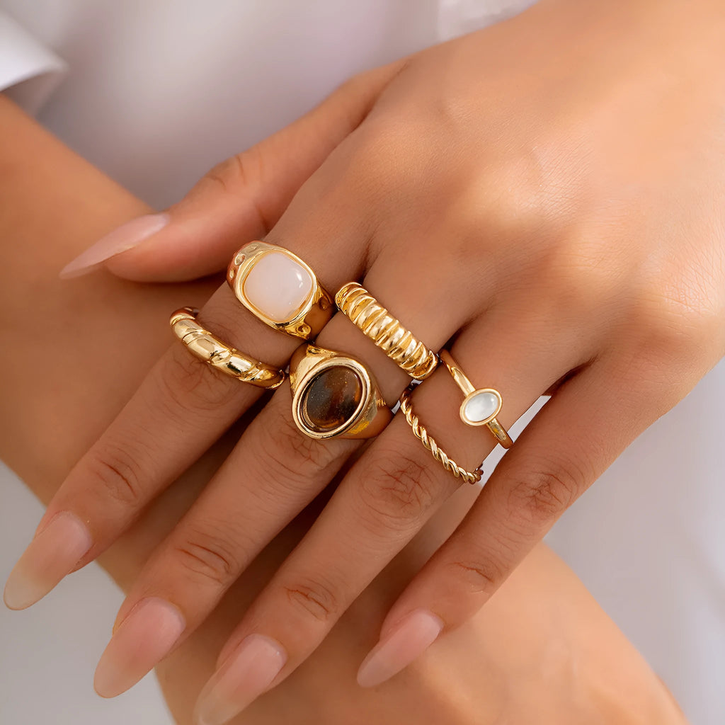 Six geometric alloy rings with light gold electroplated finish arranged in set