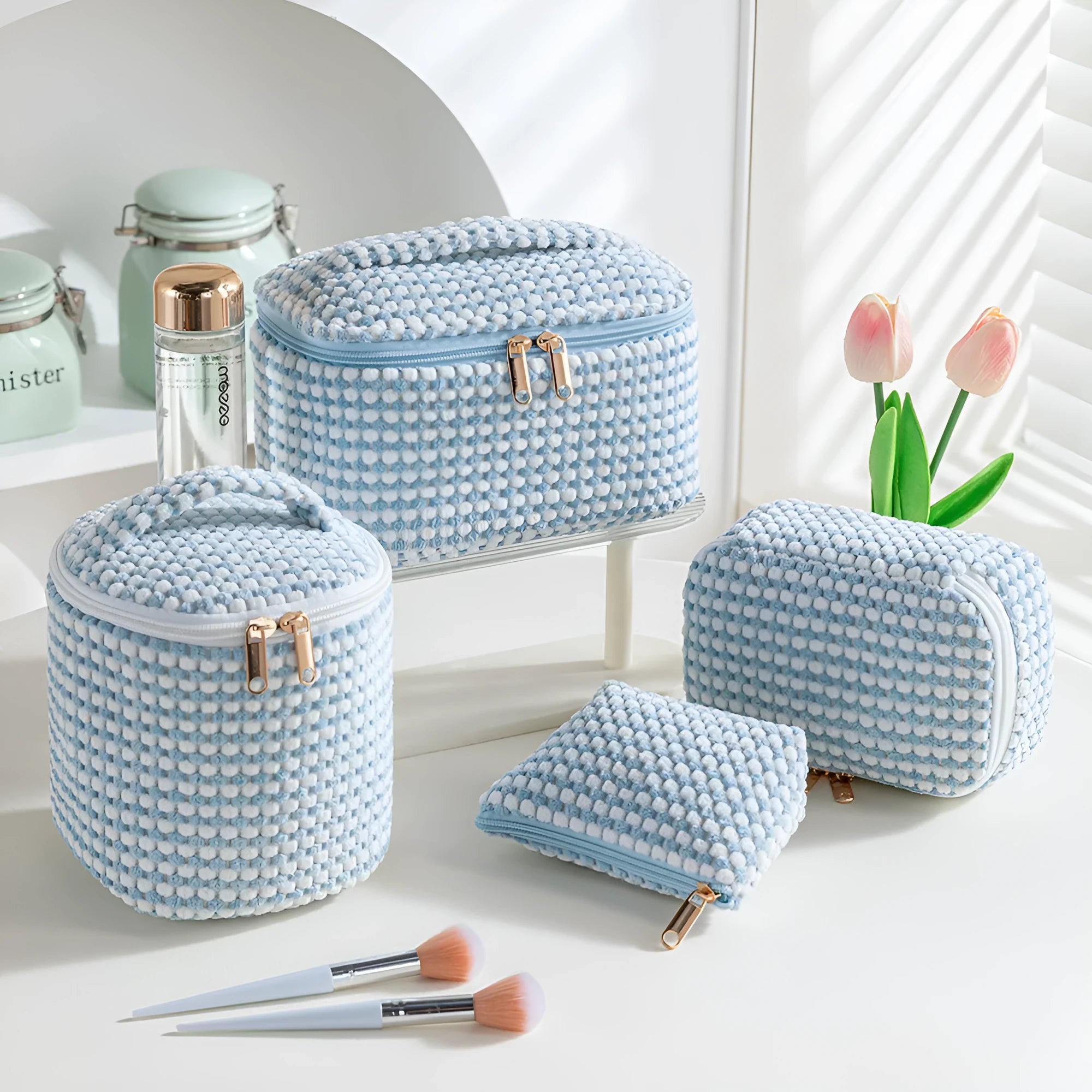 Four cube-style flannelette makeup bags in matching blue with white dots design