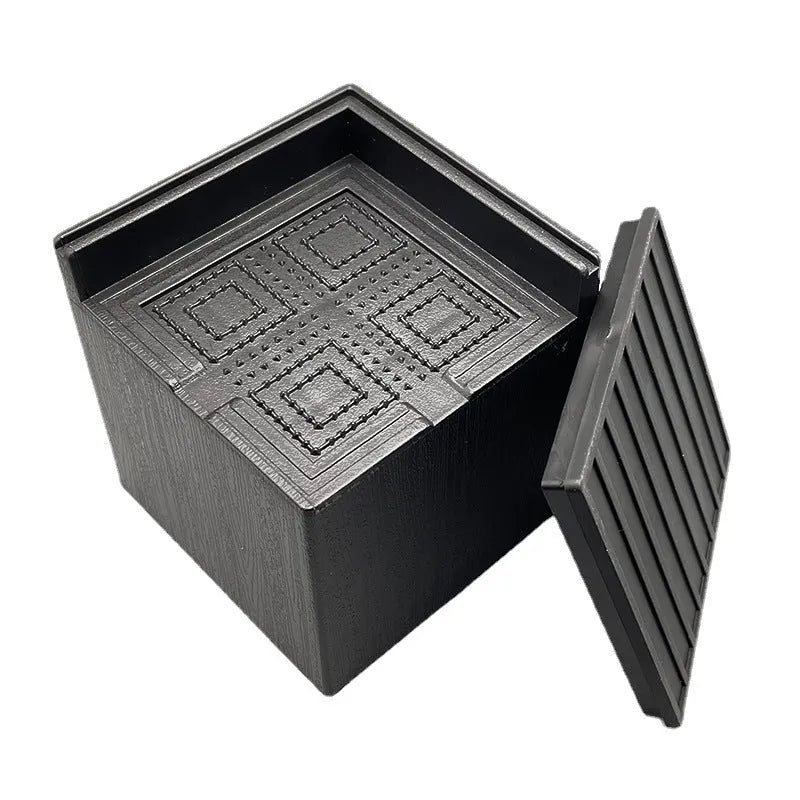 Four black plastic furniture foot mats for bed or sofa height adjustment.