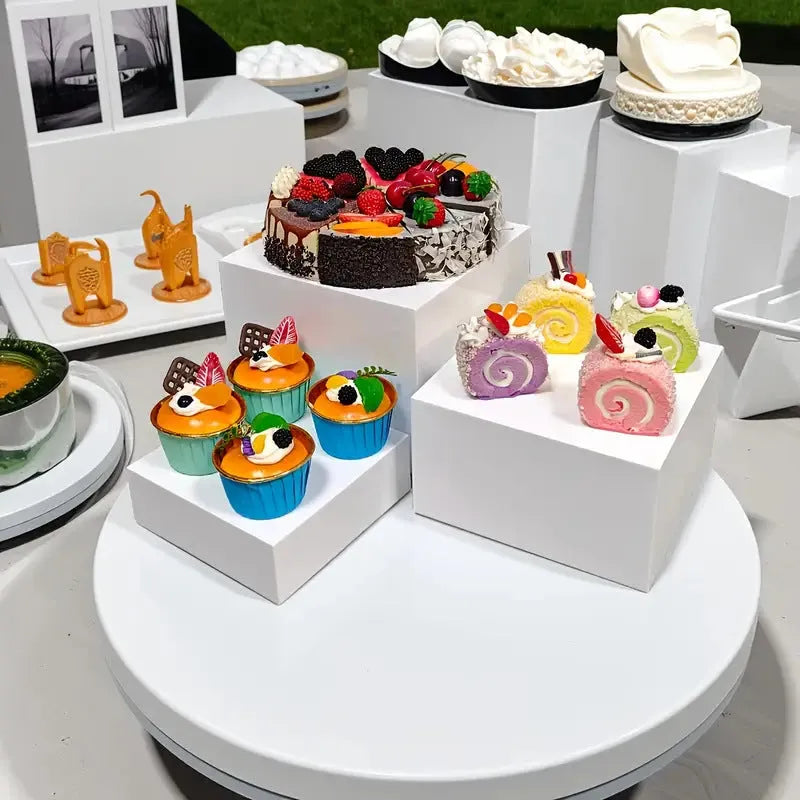 White plastic dessert display stand with six stacking cubes for tiered cake and dessert presentation